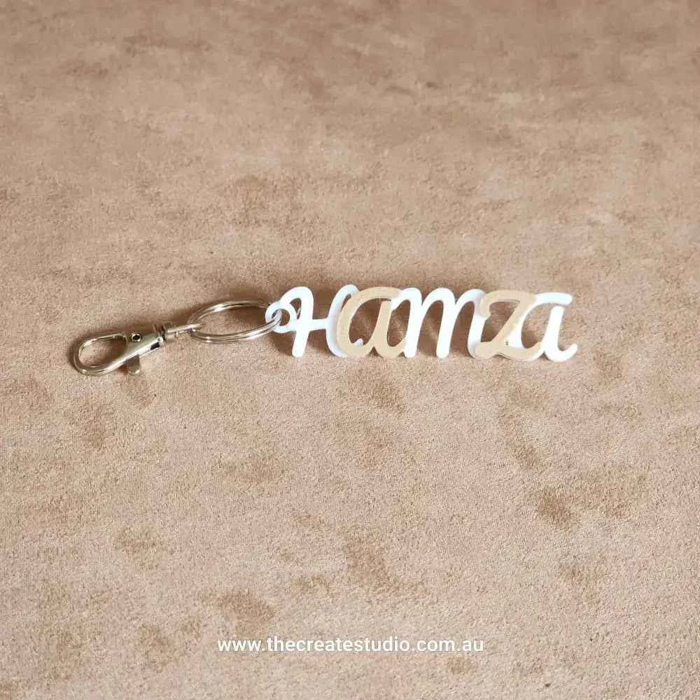 Personalised keychain with name Hamza in elegant cursive design with metal clip