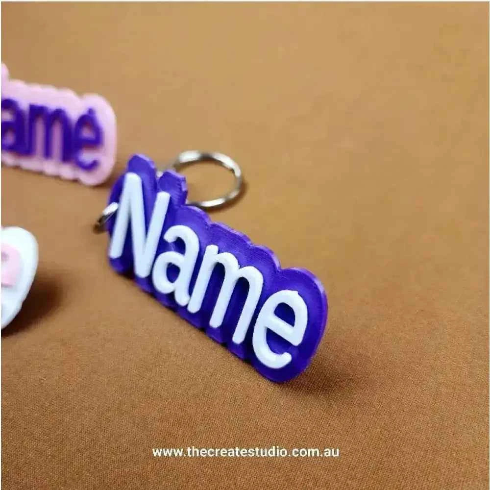 Personalised name keychain in purple with bold white lettering, perfect for gifts or personal use