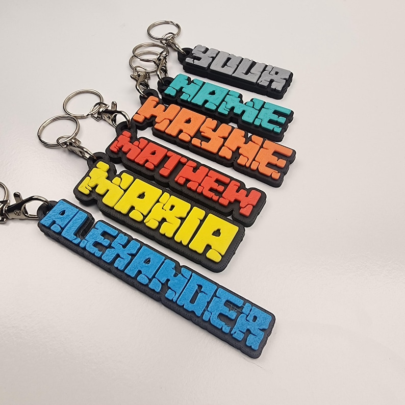 Colourful personalised name keychains featuring names like Your, Wayne, Mathew, Maria, and Alexander
