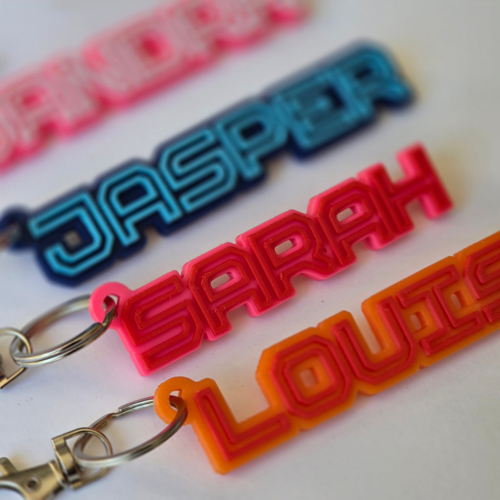 Personalised name keyring collection featuring colourful designs for unique gifting options