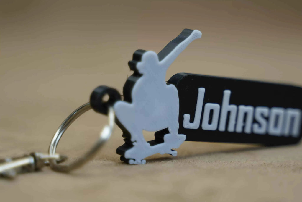 Personalised skater keychain featuring a skateboarder silhouette and custom name Johnson