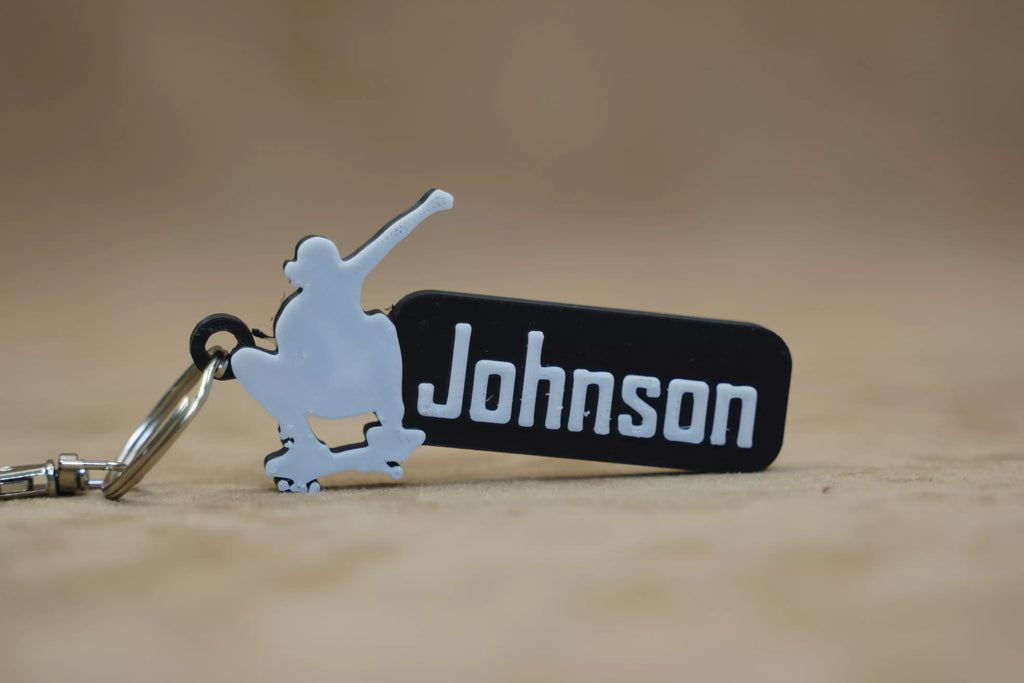 Personalised skater keychain featuring a skateboarder silhouette and custom name 'Johnson'