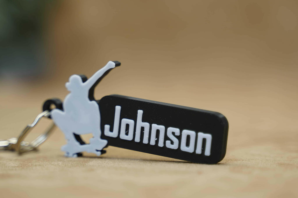 Personalised skater keychain featuring the name Johnson in stylish black and white design
