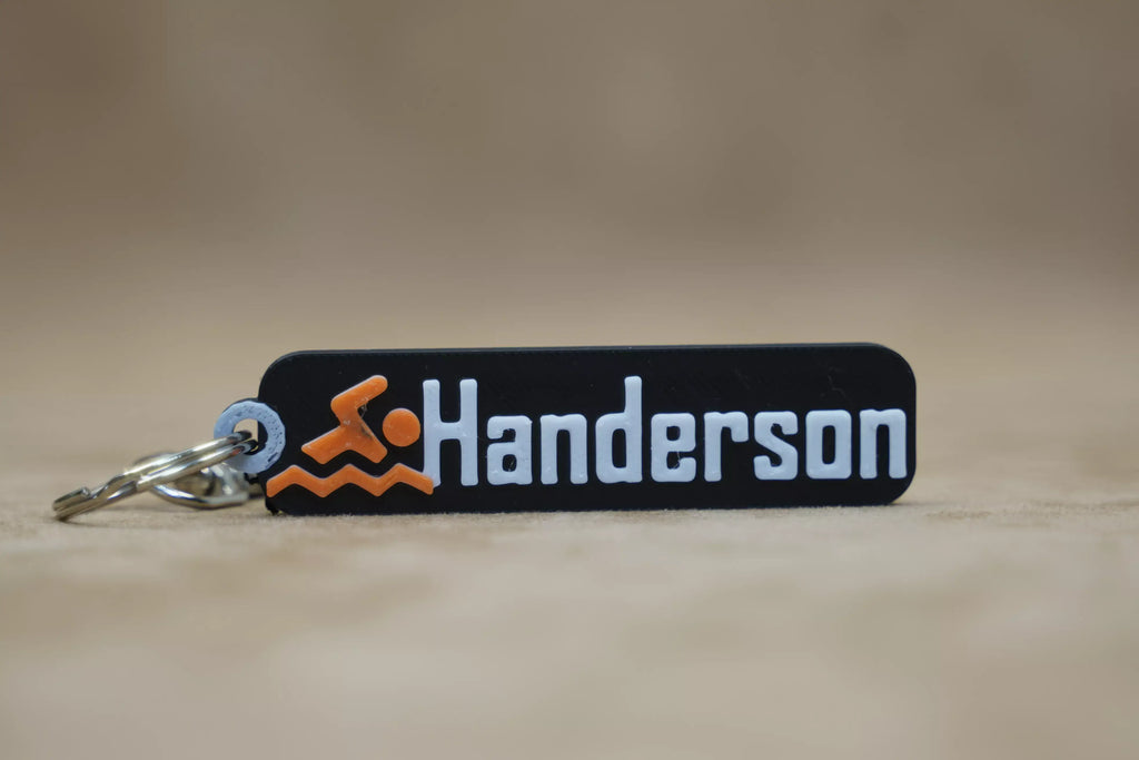 Personalised swimmer keychain featuring the name Handerson with a swimmer graphic