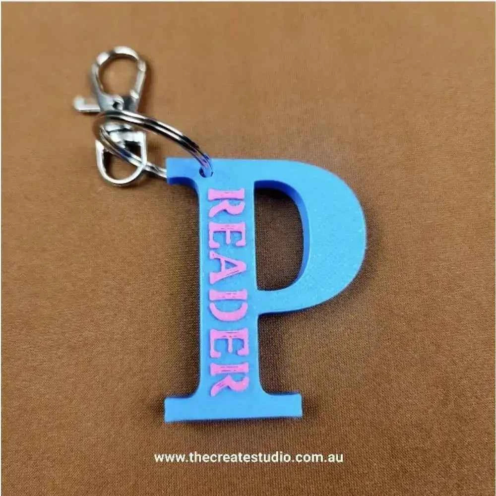 Personalized initial keychain with a blue P and pink lettering, perfect for readers