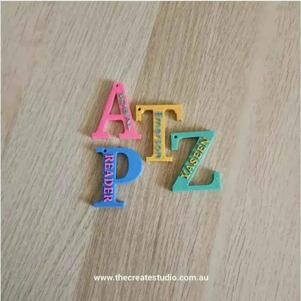 Colourful personalised initial keychain pieces in various letters for customisation