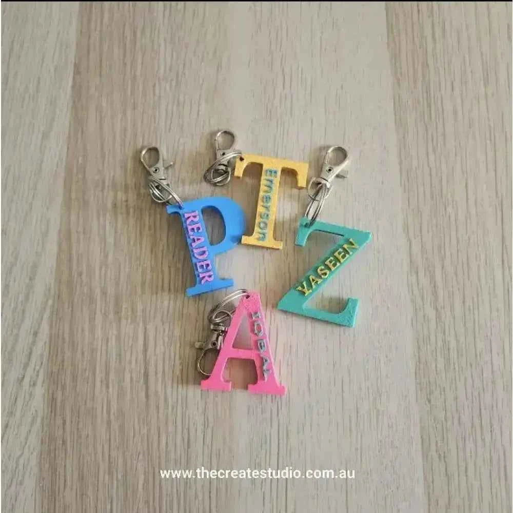 Colourful personalised initial keychain collection featuring various initials and clips