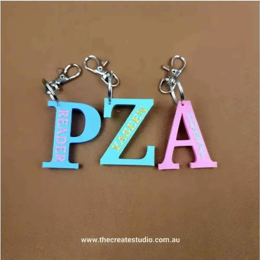 Colorful personalized initial keychain set featuring letters P, Z, A in vibrant hues and stylish fonts