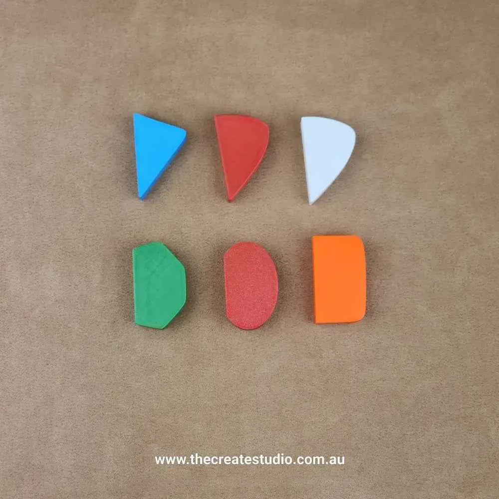 Colorful pottery mug handle molds set in various shapes for creating unique pottery designs