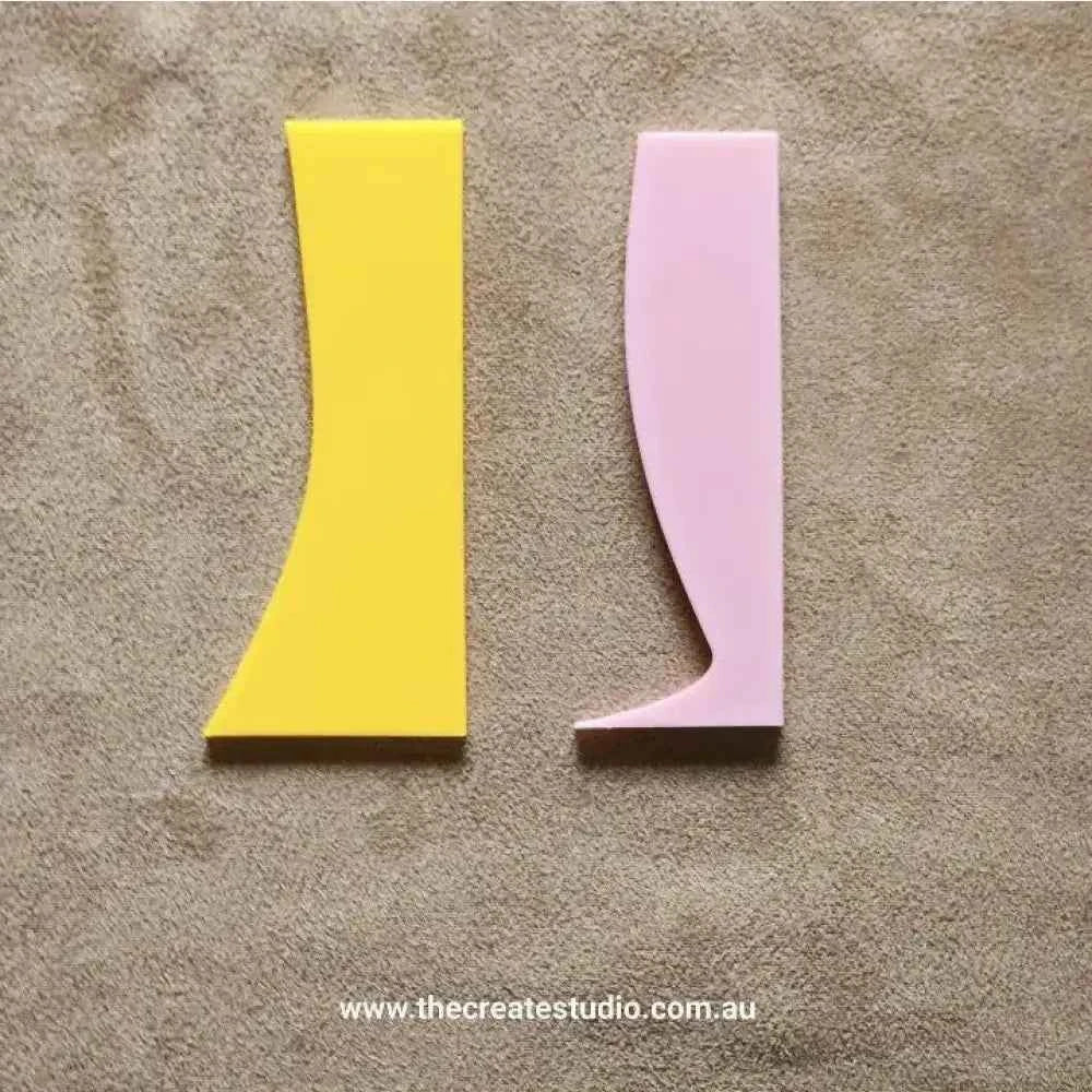 Colorful pottery rib tool set featuring pink and yellow tools for shaping clay