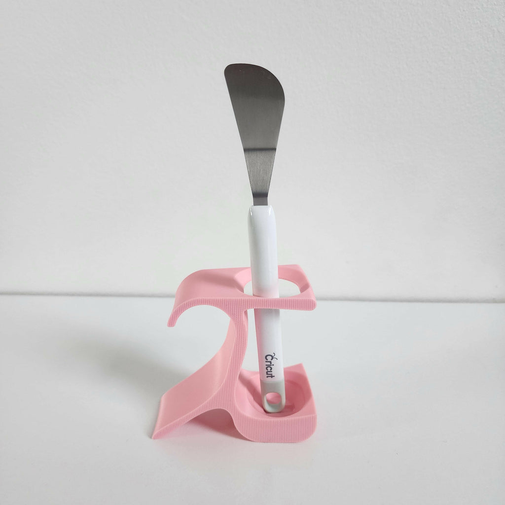 Pottery wheel tool holder in pink with a metal spatula for organized sculpting tools
