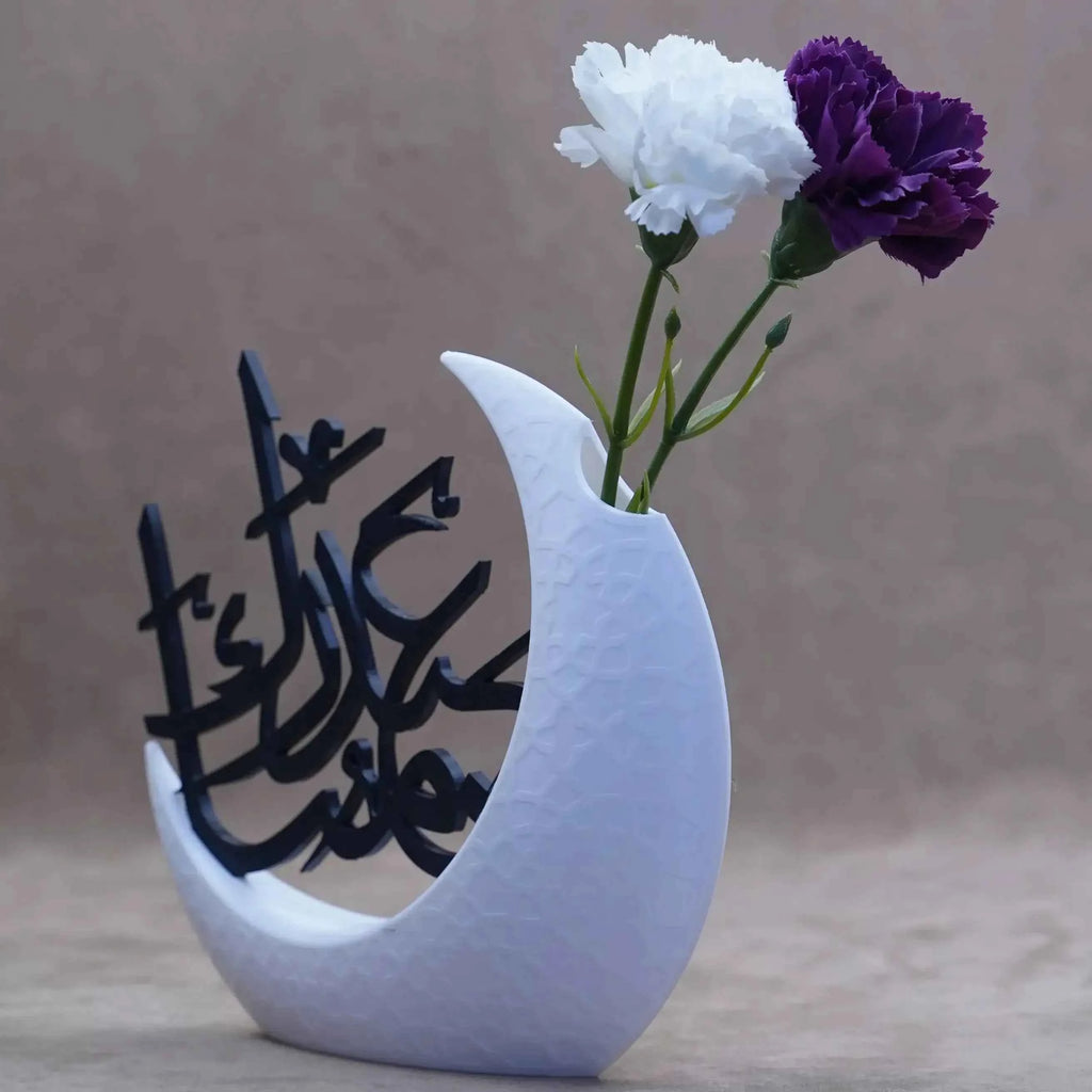 Ramadan table decor featuring a white crescent vase with calligraphy and flowers