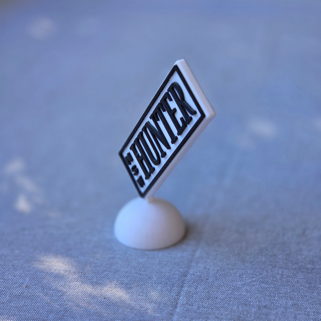 The Create Studio miniature HUNTER plate on white stand on blue fabric unique car registration plate gift