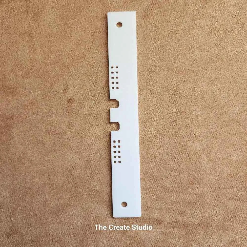 White plastic bee hive entrance reducer with ventilation holes and centre notch for hive control