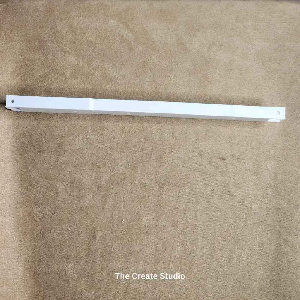 White metal support bar on beige carpet by The Create Studio showing deep side bars for bee keeping installation