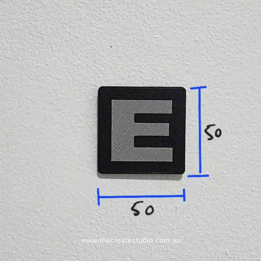 Personalised family tree gift featuring a sleek black square with a stylized letter E in gray