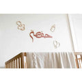 Unique baby room Arabic art featuring playful wooden designs of bottles and pacifiers
