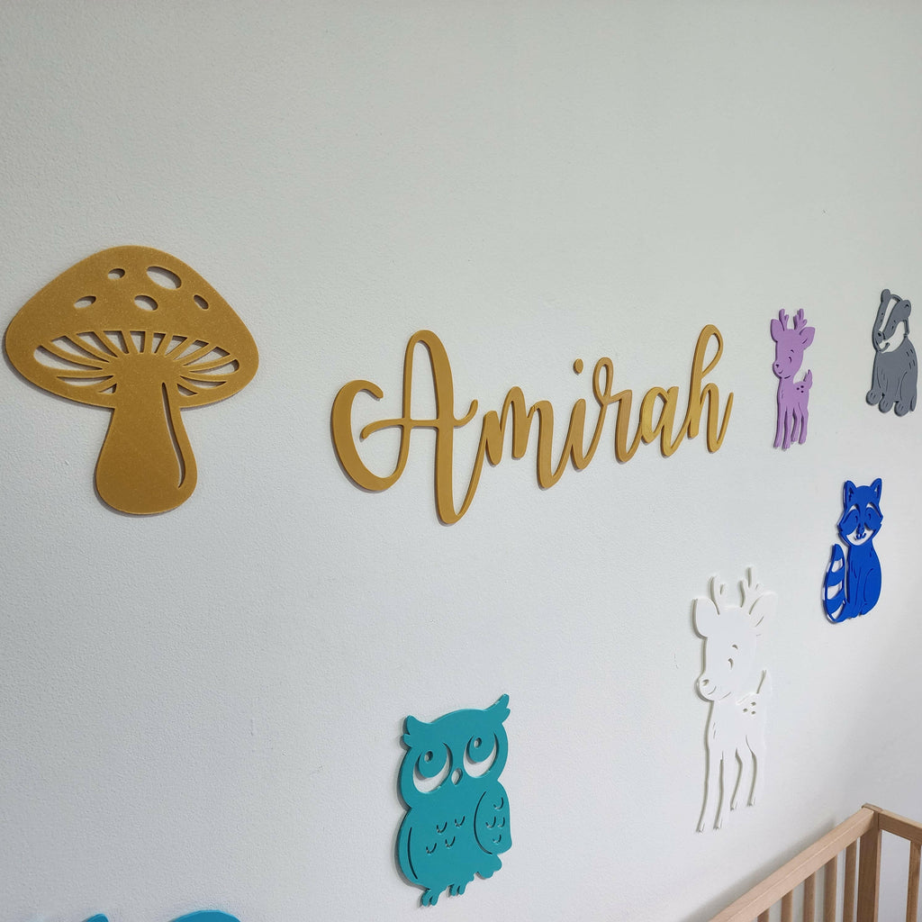 Wooden woodland creature nursery decorations including mushroom, owl, deer, raccoon, and personalized name Amirah wall decor